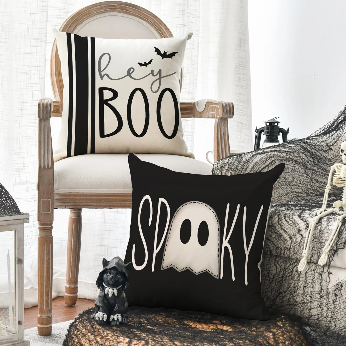A set of four Halloween cushion covers featuring ghost, pumpkin, and skull designs on black and white fabric.