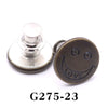A round, brass-colored button pin with a smiling face engraved on it.