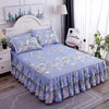 A light blue printed bed skirt with ruffled edges is displayed on a bed in a bedroom setting.