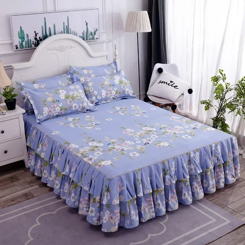 A light blue printed bed skirt with ruffled edges is displayed on a bed in a bedroom setting.