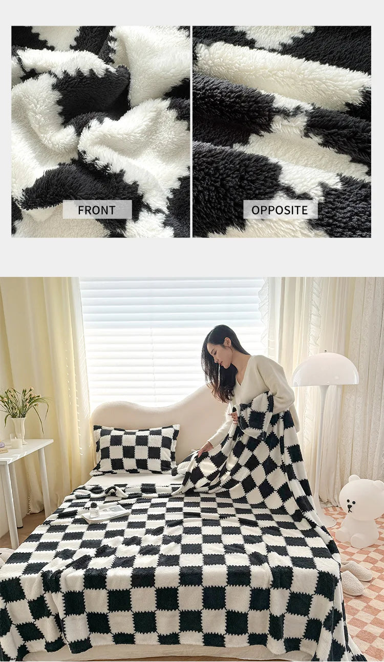 A black and white checkered flannel blanket with a soft, fluffy texture is displayed on a bed.