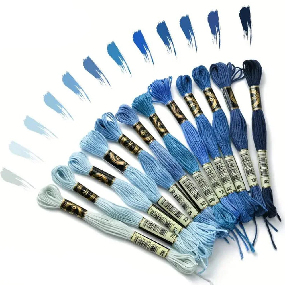 A collection of 12 pack rainbow gradient embroidery floss threads in various shades and colors laid out for crafting.