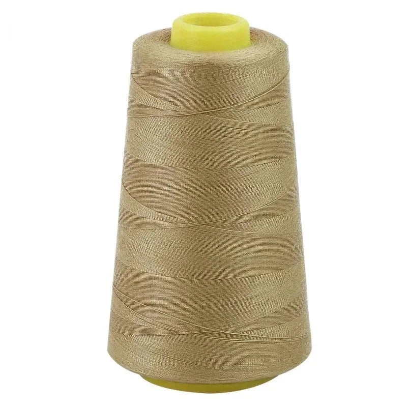 A roll of beige sewing thread with a yellow core and plastic spool visible.