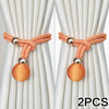 Two sets of adjustable French ball curtain tiebacks in orange thread with silver metal findings