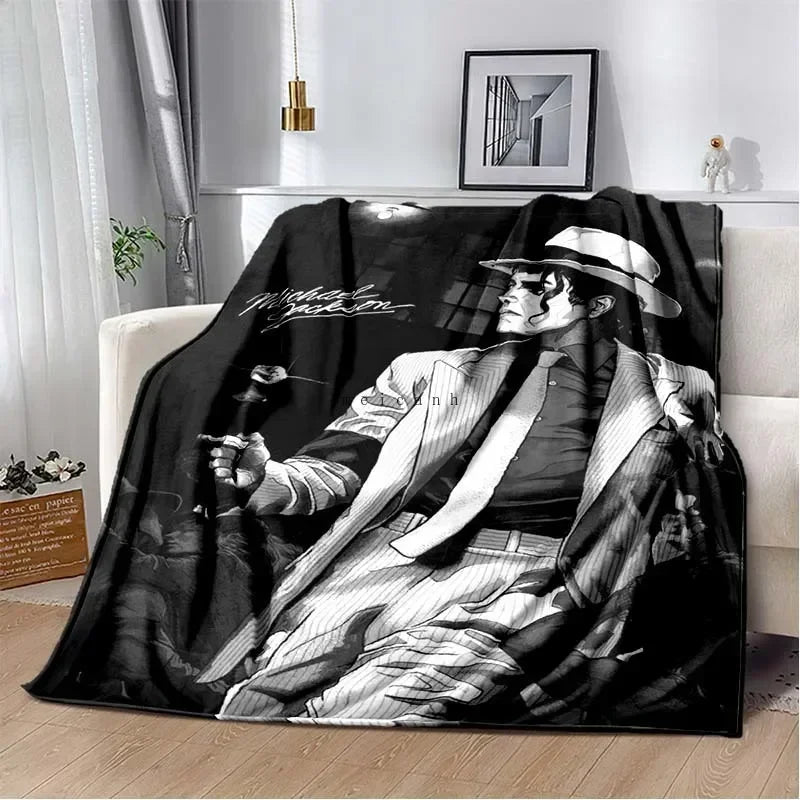 A black and white print of a man in a hat playing a guitar, displayed as a flannel blanket.