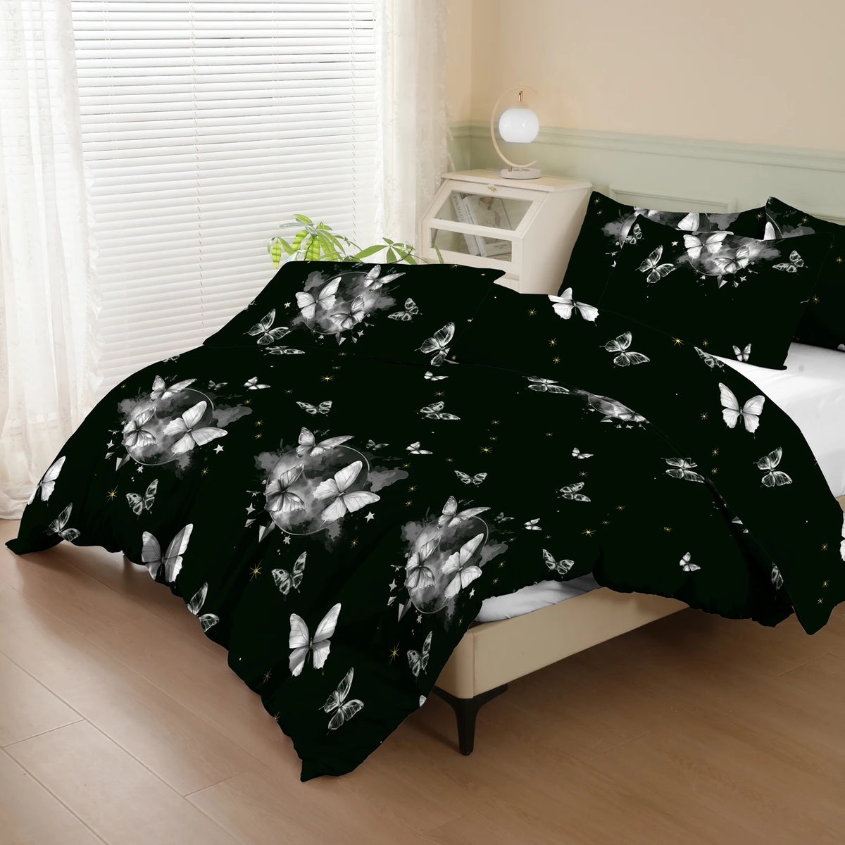 Black duvet cover set with a white butterfly print and matching pillowcases displayed on a bed.