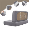 A gray water repellent stretch sofa and chair cover with a brown panel and zippered closures.