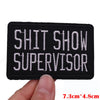 Black embroidered patch with white text SHIT SHOW SUPERVISOR