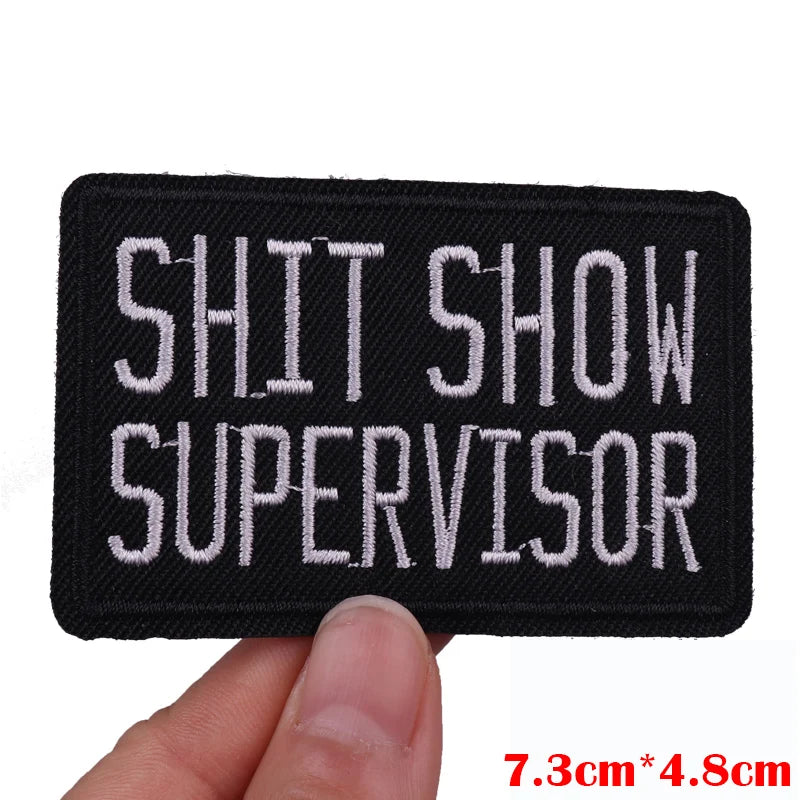 Black embroidered patch with white text SHIT SHOW SUPERVISOR