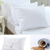 White waterproof pillow protector with a nylon zipper closure and breathable layer shown next to a soiled pillow.