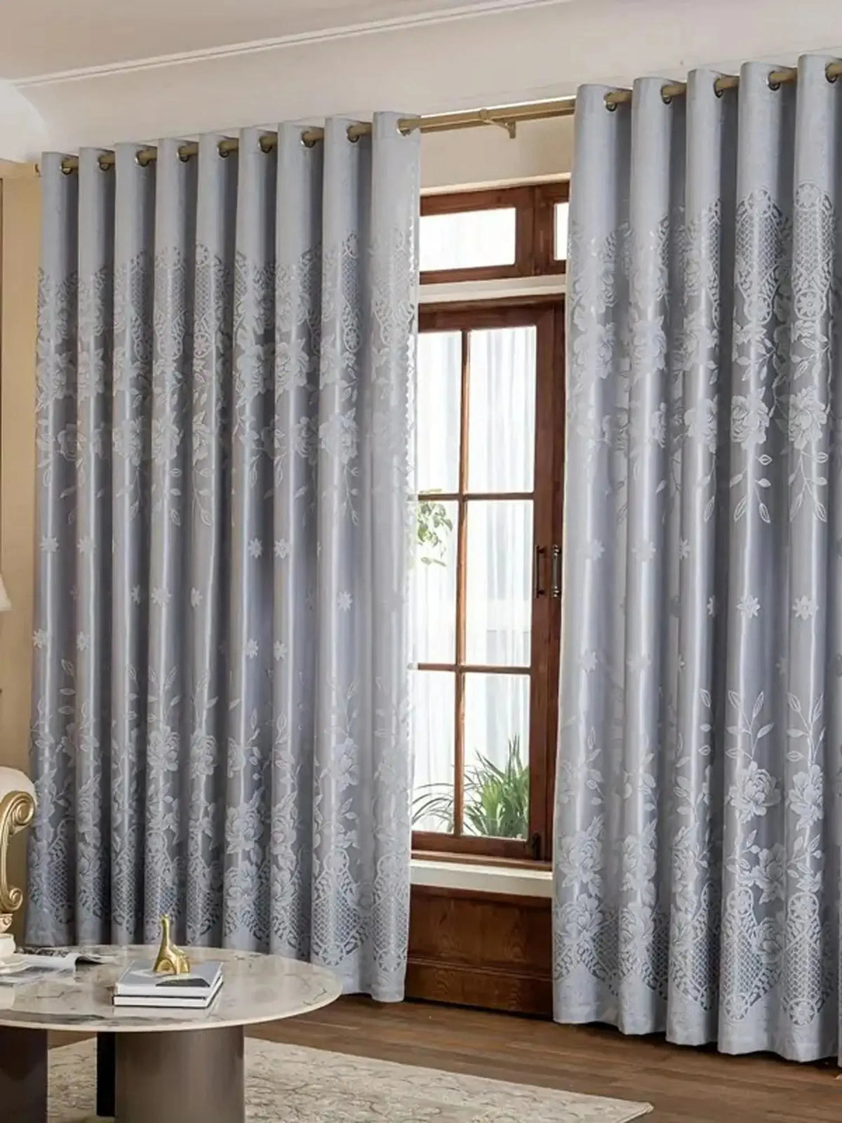 Light gray vintage floral blackout curtains framing a wooden door and window.