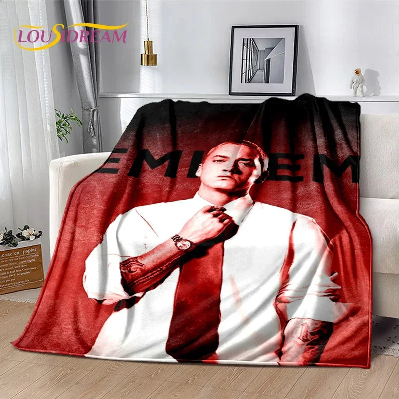 A vintage-inspired graphic throw blanket featuring a portrait of Eminem in red and white tones.
