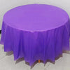A round purple plastic disposable table cover spread on a white floor.