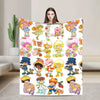 A colorful illustration of various Strawberry Shortcake characters on a plush throw blanket.
