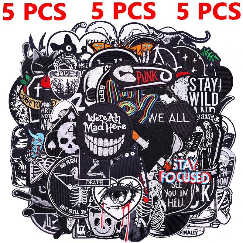 A collection of assorted black and white embroidered punk patches for DIY clothing.