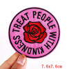 Pink letter embroidered iron-on patch with the text Treat People With Kindness on a circular background