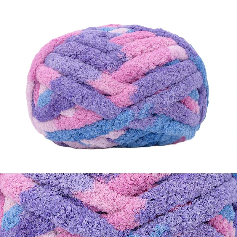 A ball of hand-knitted wool finger line scarf in purple and pink colors.