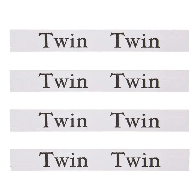 A set of four elastic bed sheet organizer straps, each labeled Twin to Twin.
