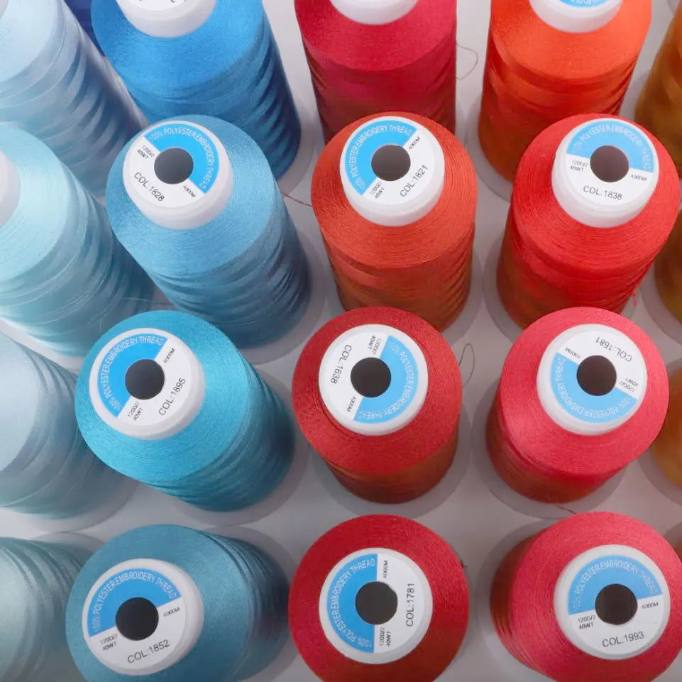 Bulk rolls of premium polyester embroidery thread in various colors including blue, red, and orange.