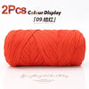 Two skeins of bright orange elastic yarn displayed for crafting