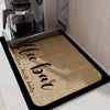 A black drainer mat with the text 'Coffee Bar fresh daily' is placed under an insulated coffee cup.