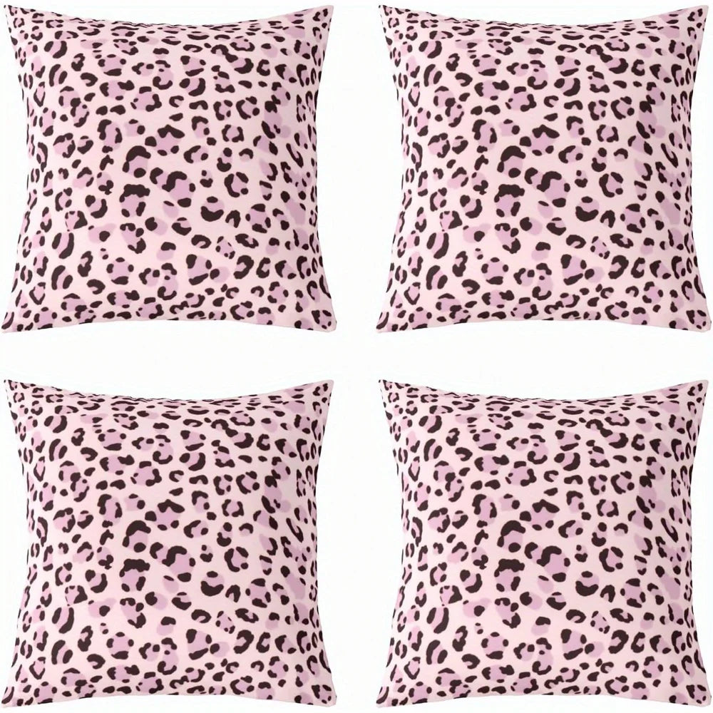A set of four pink leopard print decorative pillow covers.