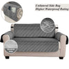 Gray quilted sofa slipcover with a unilateral side bag and waterproof rating details.