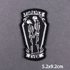 Black embroidered patch featuring two skulls and the word forever on a dark background