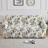 A floral print elastic sofa cover protector featuring orange, purple, and green leaves on a white background.