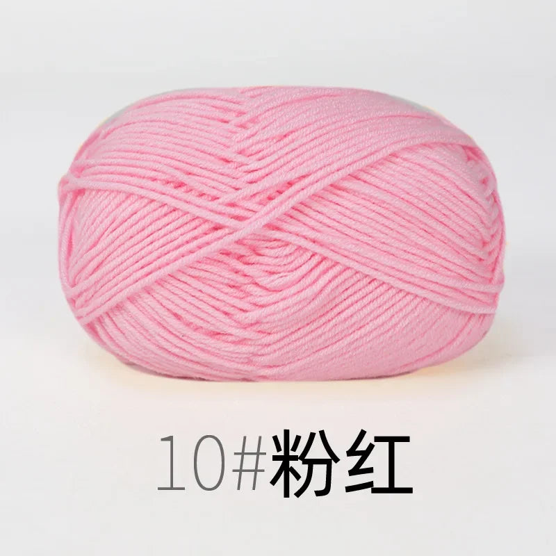 A ball of pink organic cotton 4ply knitting yarn for crafts.