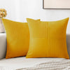 A set of four yellow corduroy throw pillow covers with a vertical ribbed texture and a patchwork design.