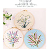 A set of three embroidery hoops featuring delicate floral patterns in shades of blue, pink, and green.