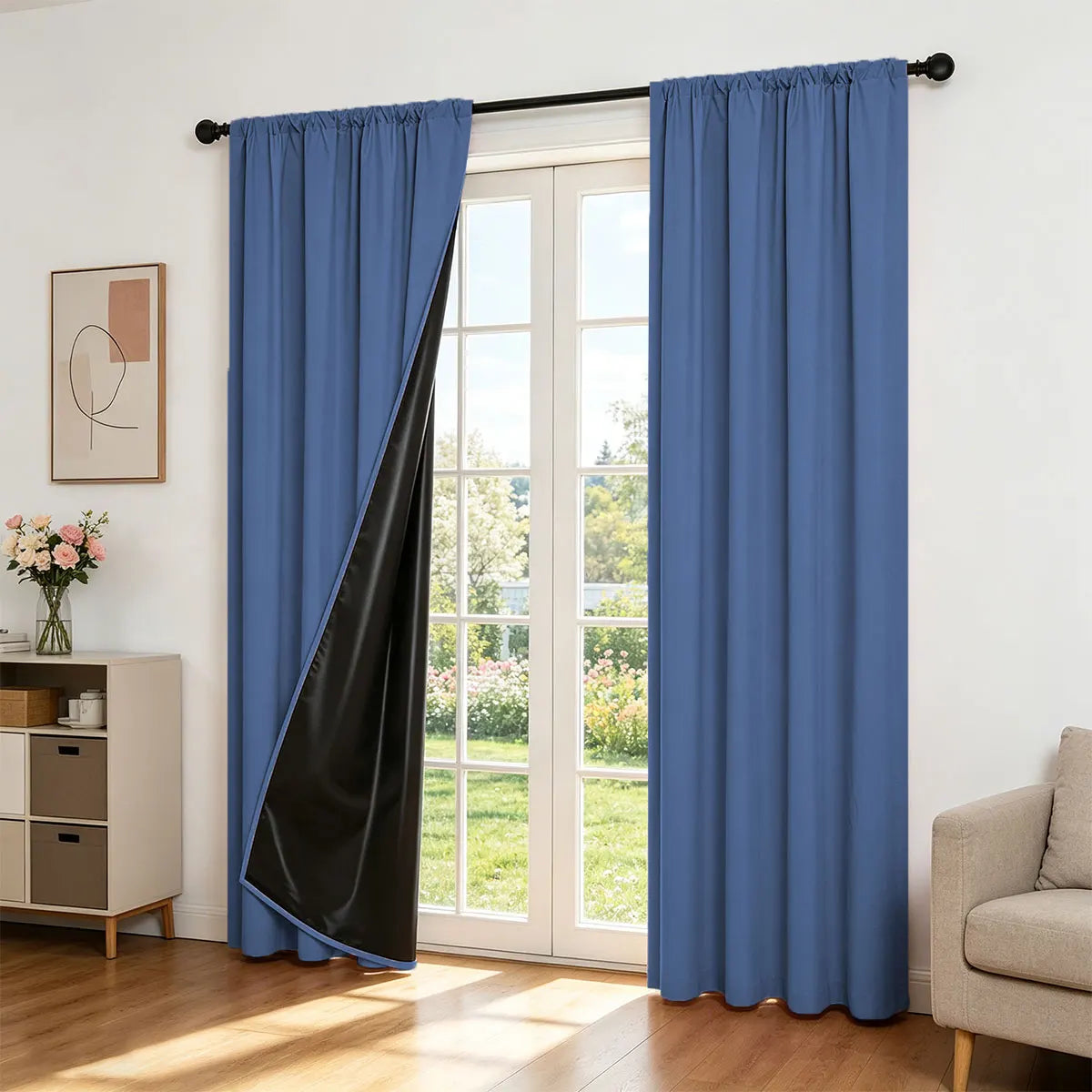 Two panels of royal blue blackout curtains with a black liner hanging in a white door frame.
