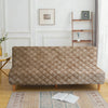 A beige velvet non-slip armless sofa cover displayed on a wooden frame with a patterned rug.