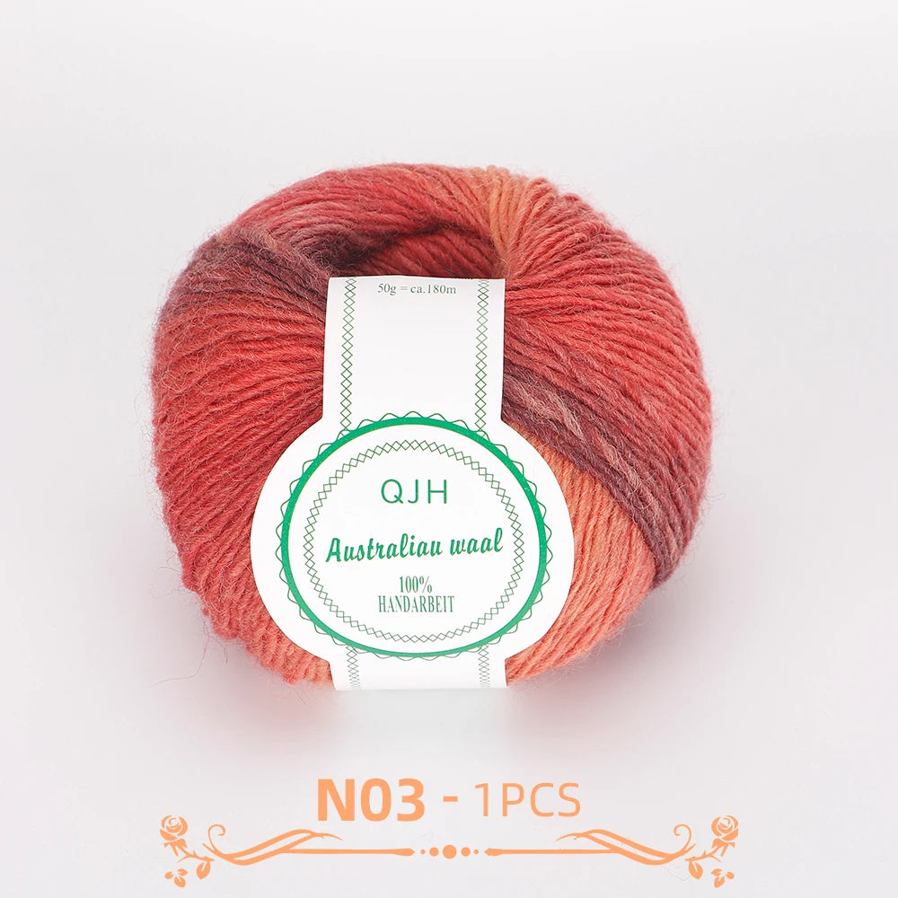 A ball of multi-colored wool yarn with shades of red and brown, labeled QJH Australiau waal 100% handarbeid.