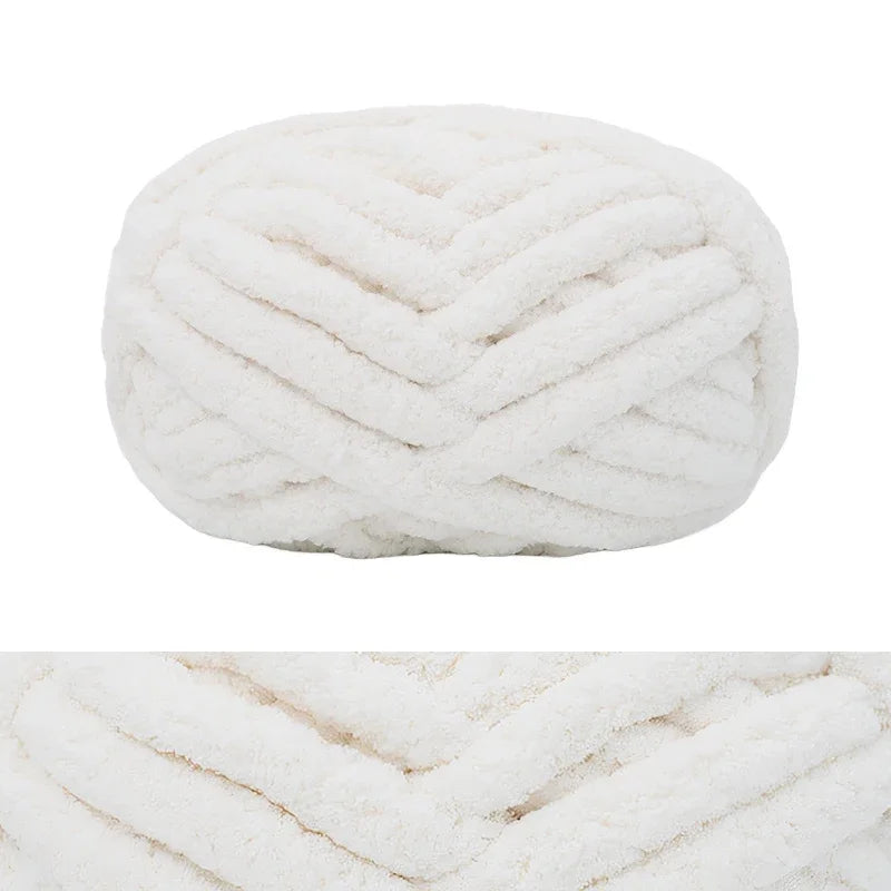 A ball of white hand-knitted wool finger line scarf with a textured, braided appearance.