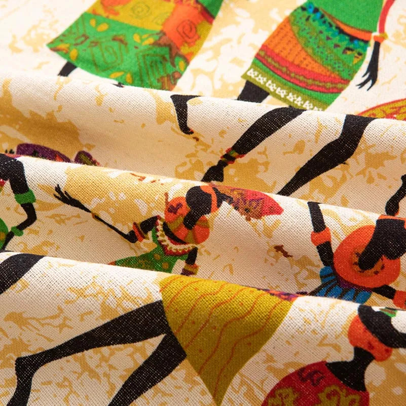 Close-up of bohemian printed linen fabric featuring geometric patterns in yellow, green, and black.