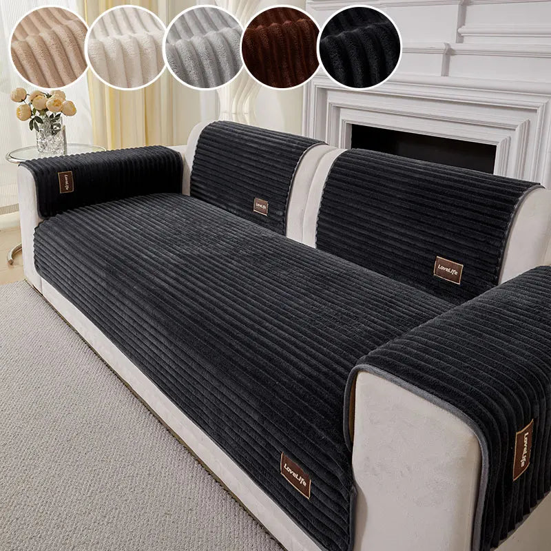 A black striped sofa cushion with light beige trim and a brown accent, shown on a white sofa.