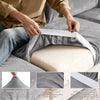 A hand is shown placing a white elastic band onto a gray sofa seat cushion cover for enhanced durability and fit.
