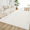A cream tie-dye shaggy rug is placed on a light wood floor in a bright living room setting.