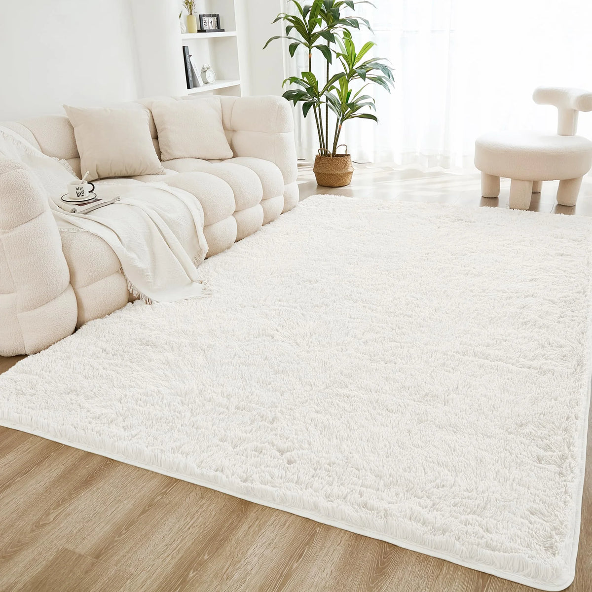 A cream tie-dye shaggy rug is placed on a light wood floor in a bright living room setting.