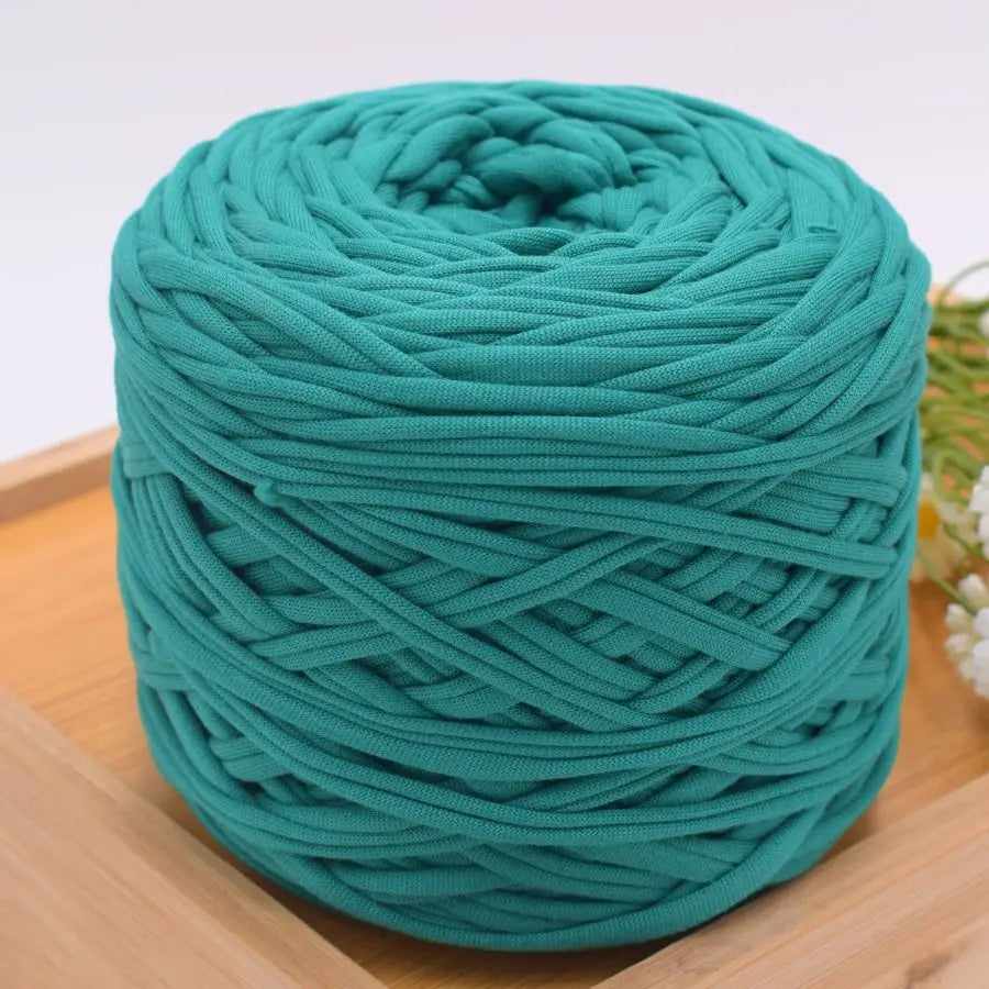 A ball of teal green craft yarn used for knitting and DIY projects.