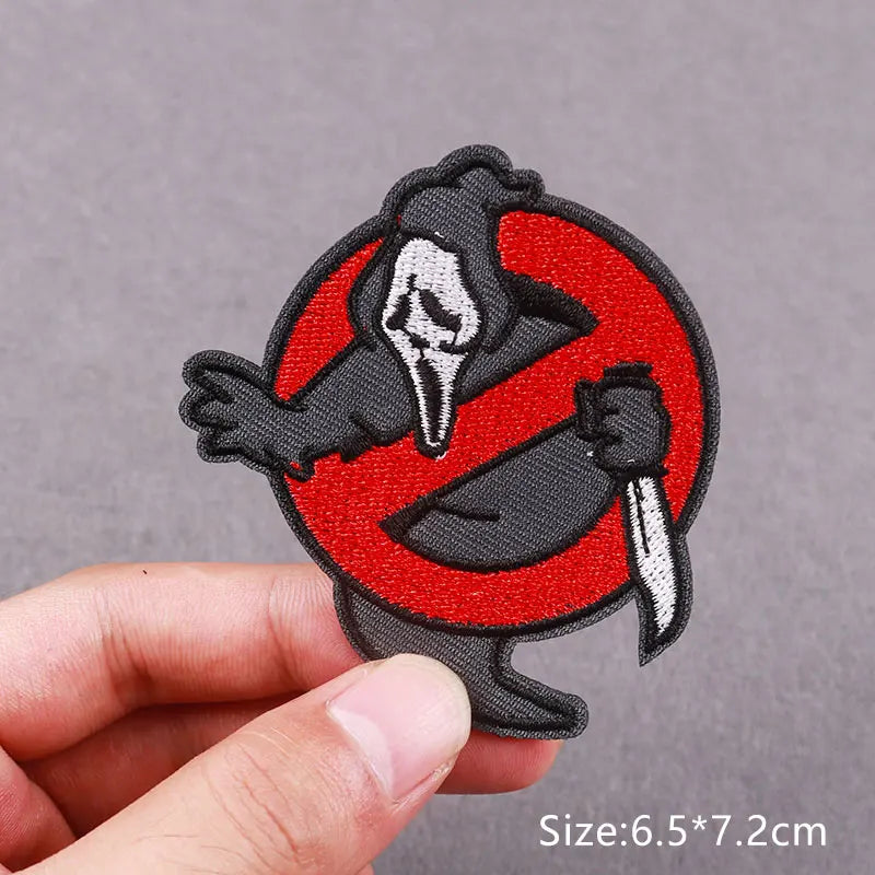 Black and white embroidered patch featuring a skull and knife design on a red circle
