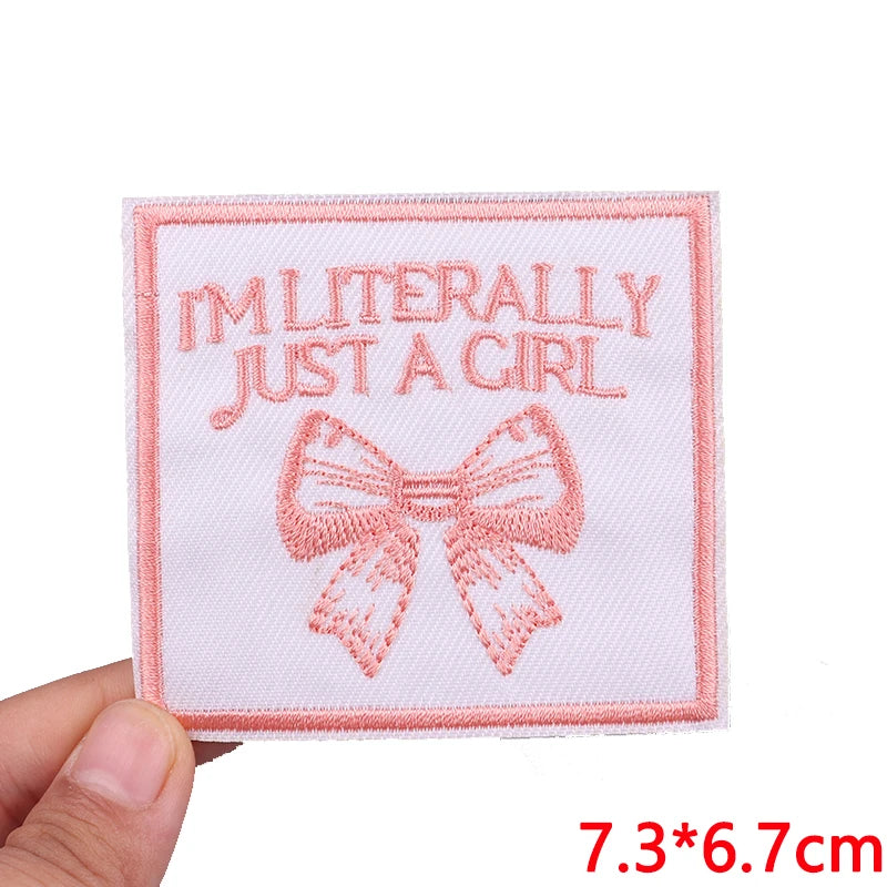 Pink embroidered patch with the text I'm literally just a girl and a bow design