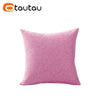 A square pink linen cushion cover with a button closure.