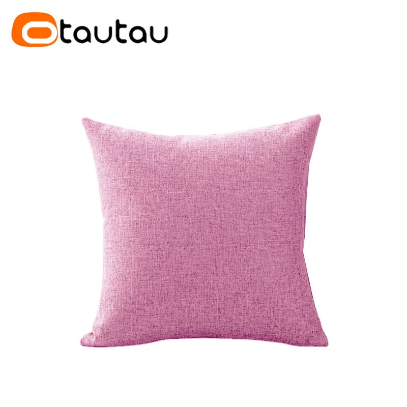 A square pink linen cushion cover with a button closure.