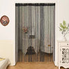 Beaded string curtains in gray and black hanging in a doorway
