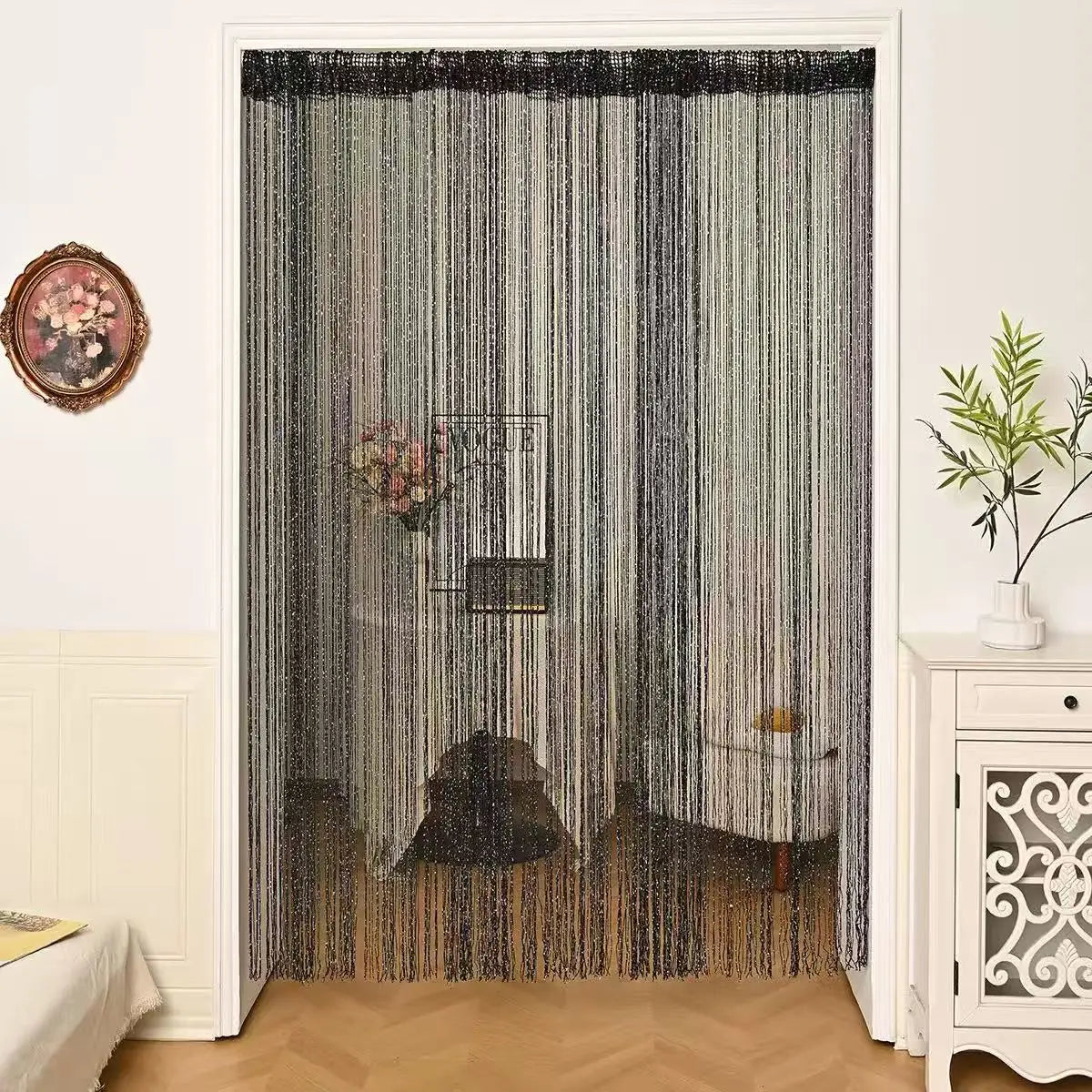 Beaded string curtains in gray and black hanging in a doorway