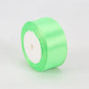 A roll of bright lime green satin ribbon for crafts and gift wrapping.