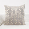 A beige and gray geometric jacquard lumbar pillow cover with a repeating maze pattern.